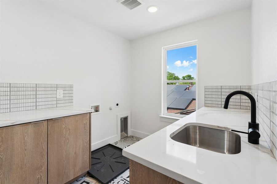 Laundry room with sink and fold counter.