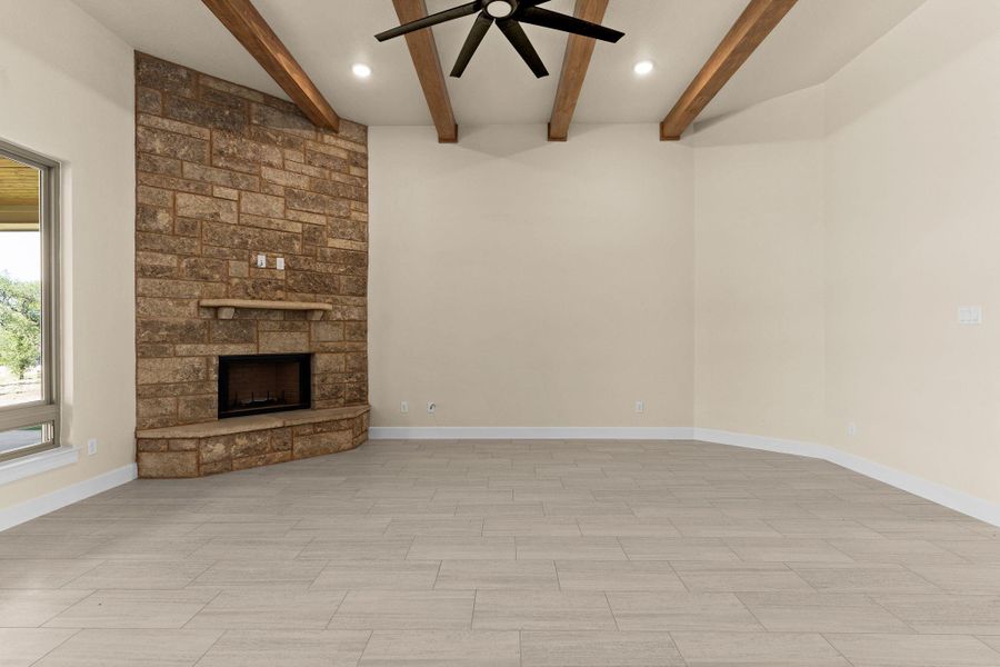 Unfurnished living room featuring a fireplace, beam ceiling, ceiling fan, recessed lighting, and wood finish floors Unfurnished living room featuring a fireplace, beam ceiling, ceiling fan, recessed lighting, and wood finish floors