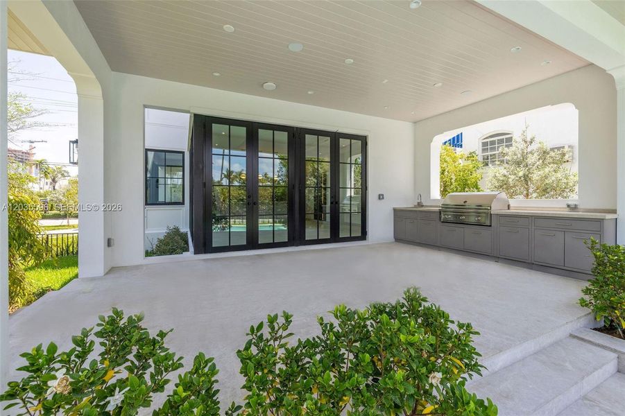Outside living room with full kitchen overlooks pool Outside living room with full kitchen overlooks pool