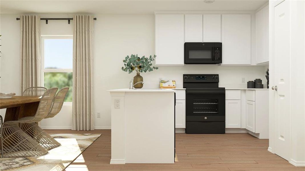 Kitchen featuring electric range, white cabinetry, and light hardwood / wood-style floors