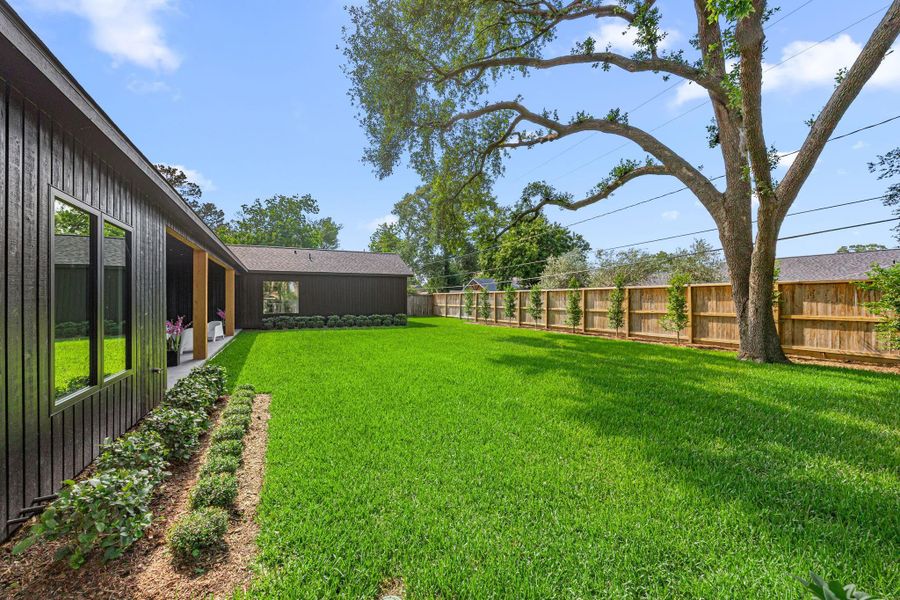 Back yard is large enough for a pool & offers a massive mature oak tree that offers shade but is not in the way.