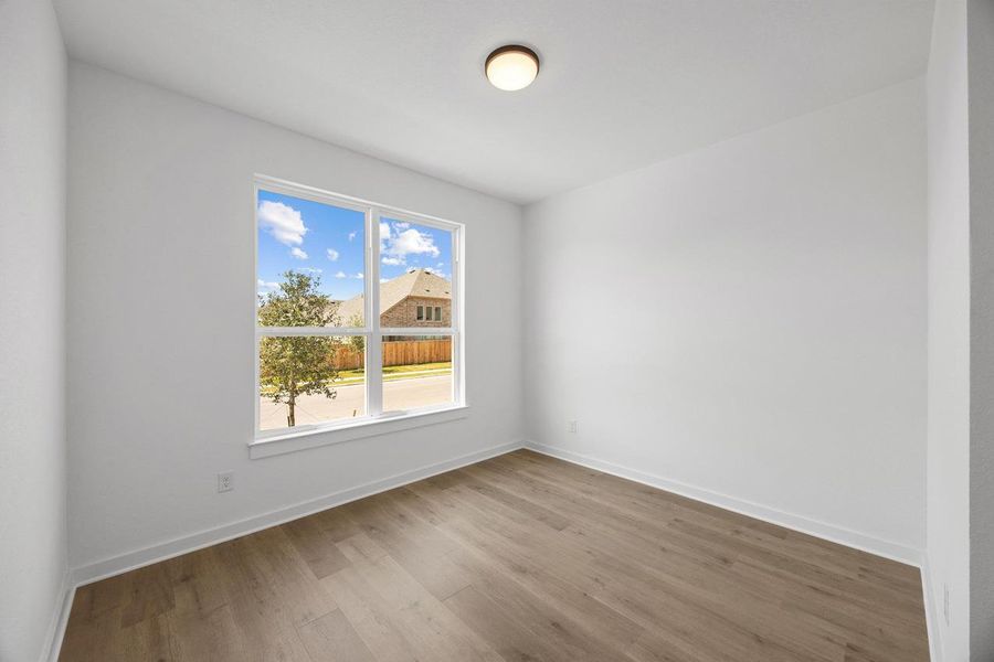 Unfurnished room with wood finished floors and baseboards Unfurnished room with wood finished floors and baseboards