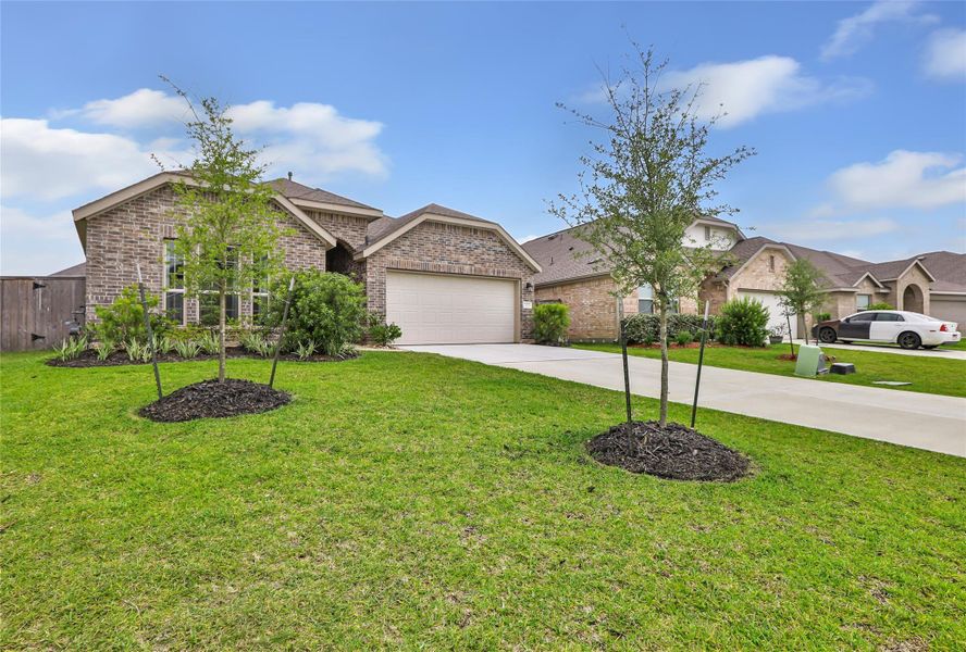 Front exterior of a new home in Pinewood at Grand Texas, New Caney, TX, highlighting curb appeal (Image 24).
