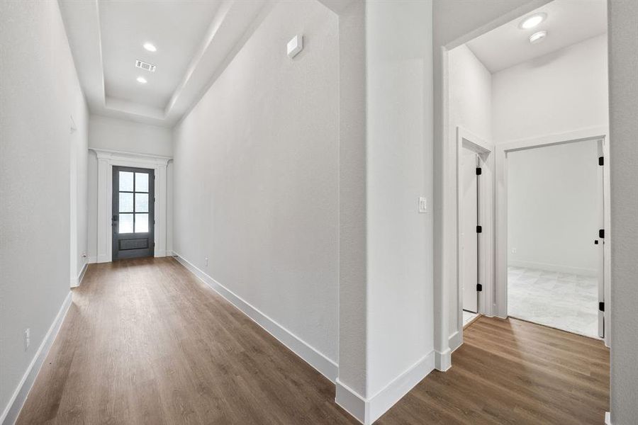 Corridor featuring dark wood-style floors and recessed lighting