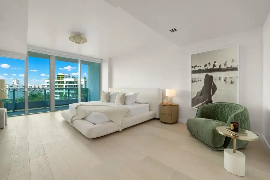 Floor-to-ceiling glass sliding doors, wood-finish flooring, and expansive balcony access featuring a metal railing Floor-to-ceiling glass sliding doors, wood-finish flooring, and expansive balcony access featuring a metal railing