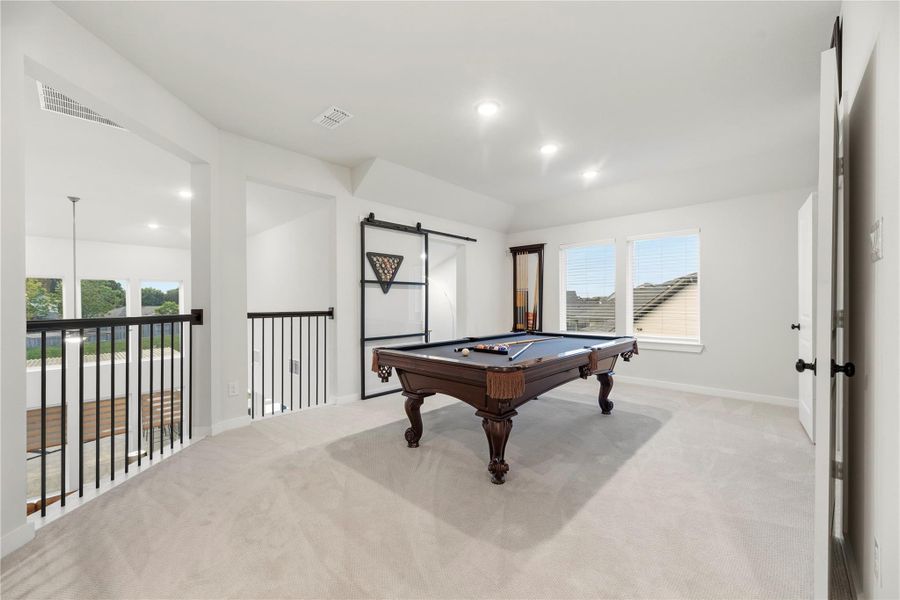 This spacious, light-filled game room is ideal for entertaining and has direct access to the media room.