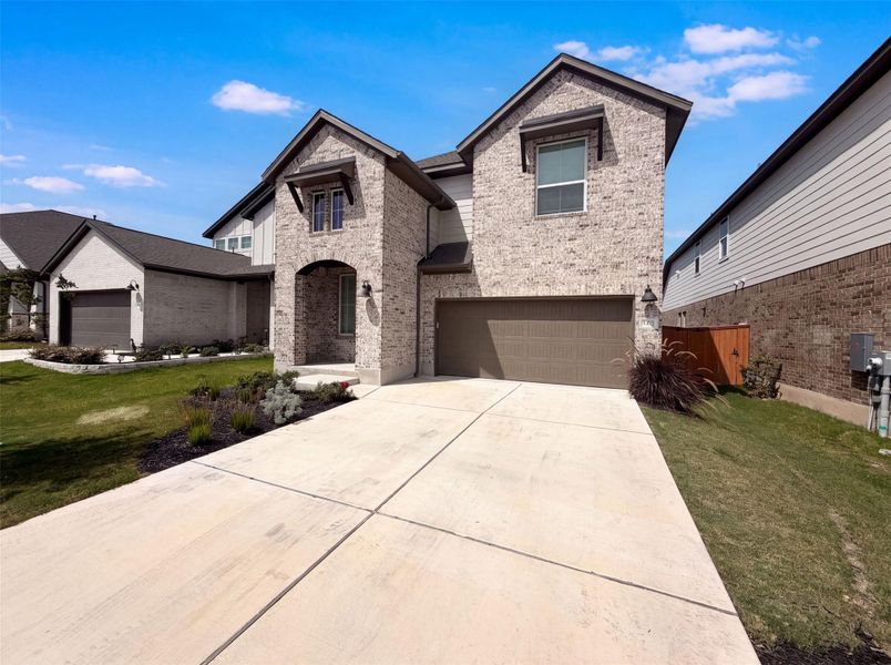A well-maintained lawn and extended driveway enhance this inviting brick and siding facade. A well-maintained lawn and extended driveway enhance this inviting brick and siding facade.