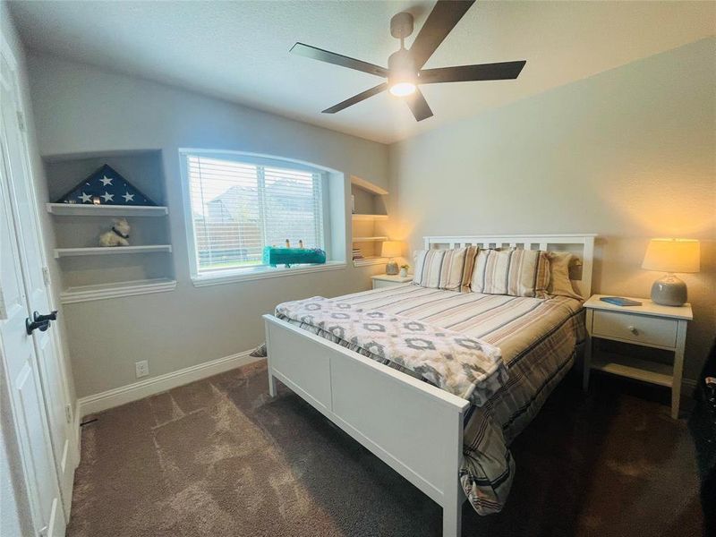 1st Floor Bedroom #3 with built-in shelves and ceiling fan.