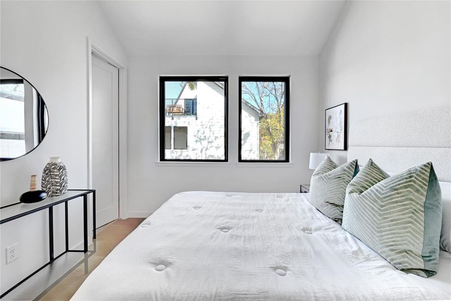 Bedroom featuring vaulted ceiling and light wood finished floors