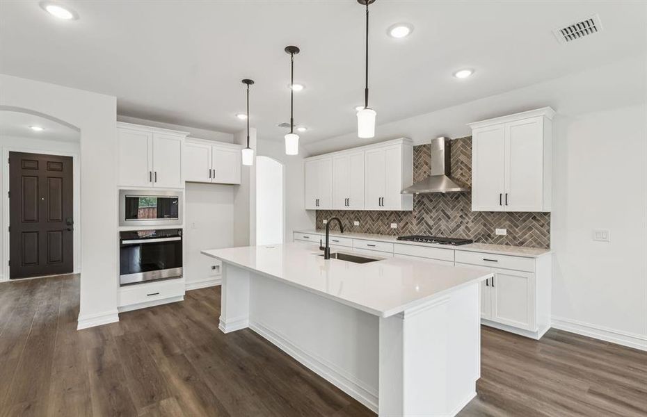 Spacious eat-in kitchen designed with a large island for dining *Model representation Spacious eat-in kitchen designed with a large island for dining *Model representation