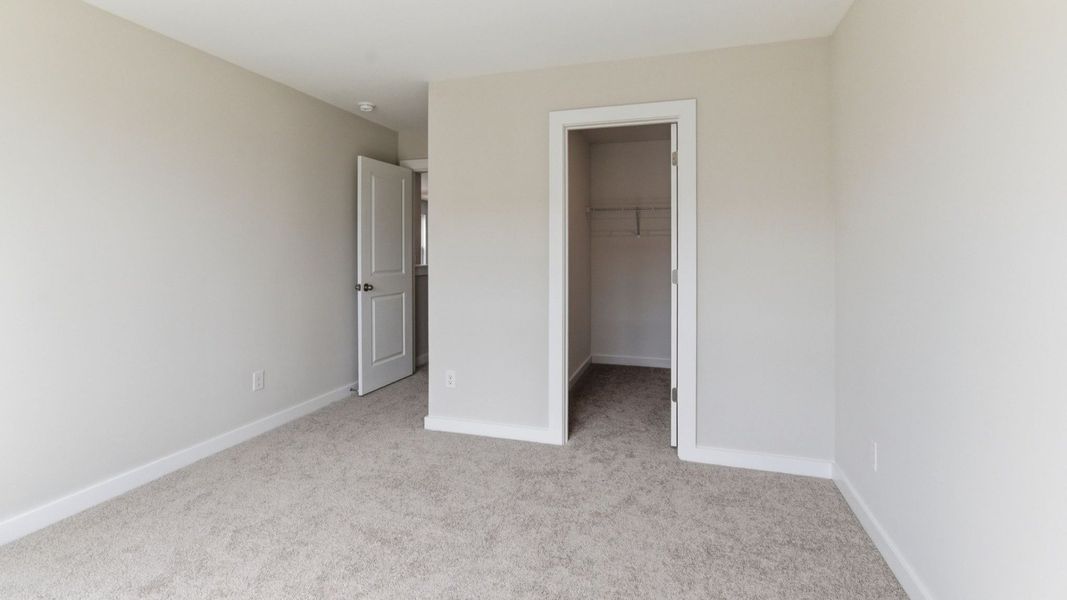 Bedroom with carpet and closet Bedroom with carpet and closet