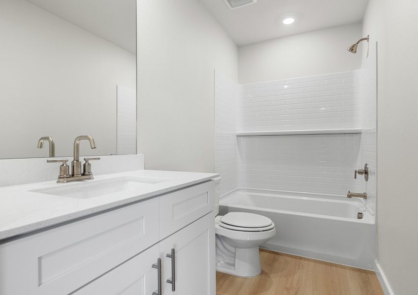 Secondary bath has a shower/tub comboe, white cabinet vanity and light luxury vinyl flooring. Secondary bath has a shower/tub comboe, white cabinet vanity and light luxury vinyl flooring.