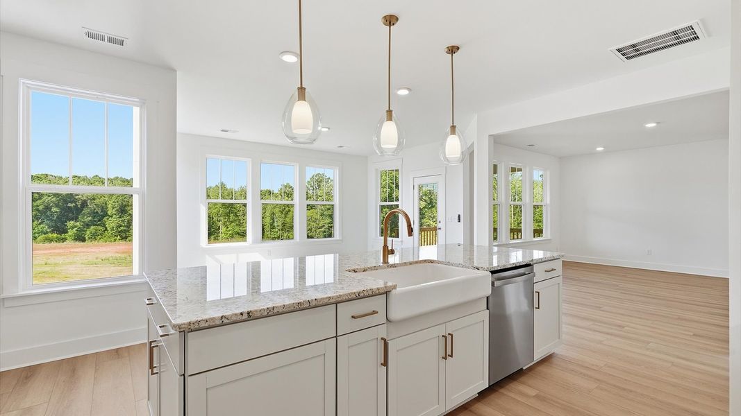 Notable kitchen space with elegant pendant lighting and a large island perfect for entertaining in Woodruff, SC