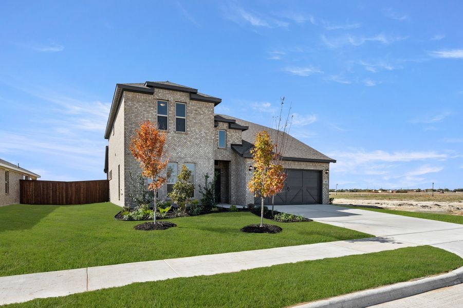 Front exterior of a new home in Myrtle Creek, Waxahachie, TX, highlighting curb appeal (Image 2). Front exterior of a new home in Myrtle Creek, Waxahachie, TX, highlighting curb appeal (Image 2).