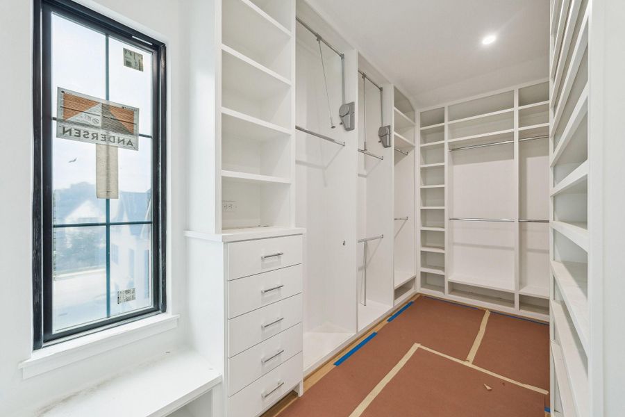 Primary Closet with built-in dresser/drawers, pull-downs, shoe rack and more!