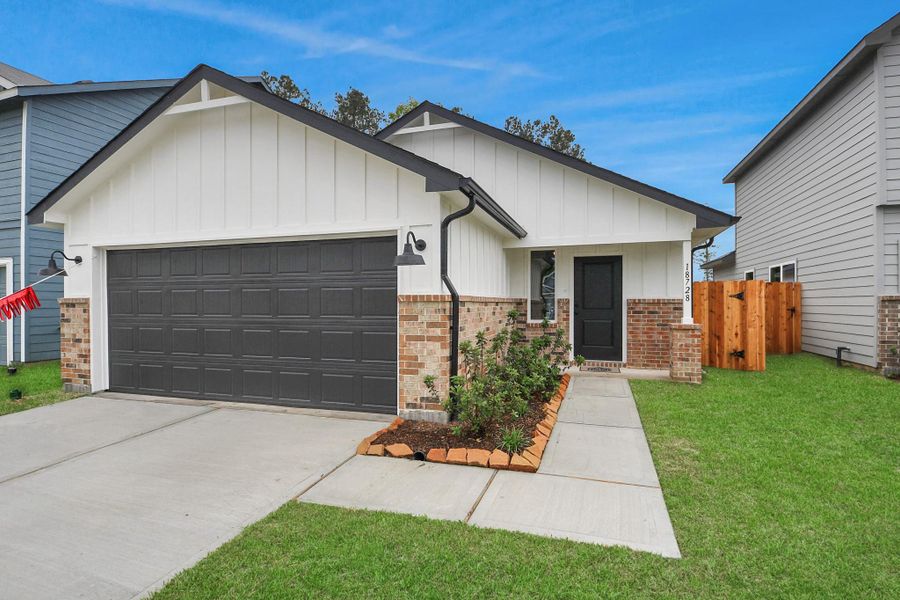 Front exterior of a new home in The Enclave at Spring Branch, Montgomery, TX, highlighting curb appeal (Image 1). Front exterior of a new home in The Enclave at Spring Branch, Montgomery, TX, highlighting curb appeal (Image 1).