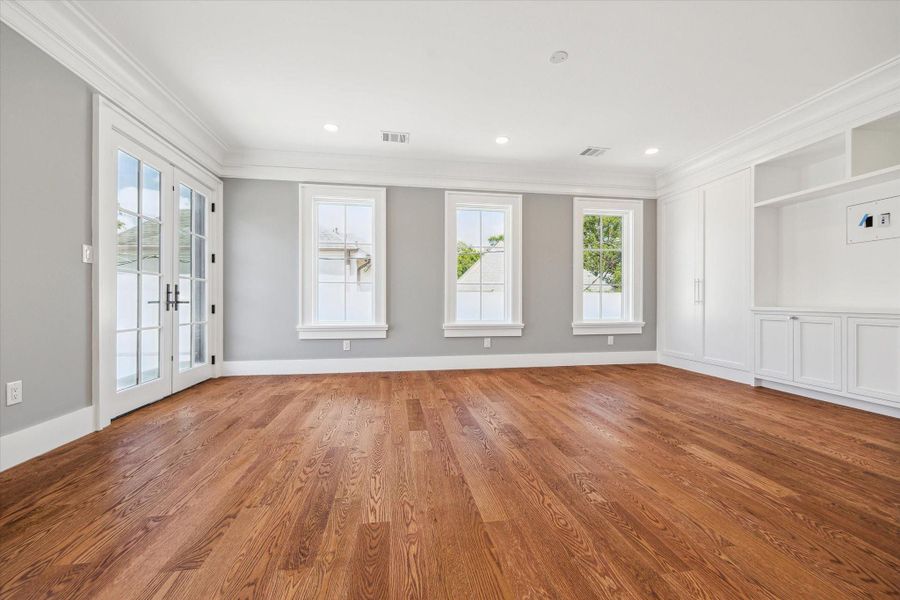 This secondary bedroom could also be used as a 2nd floor living area as it opens to the balcony!  There is built-in shelving and modern recessed lighting, creating an inviting atmosphere.