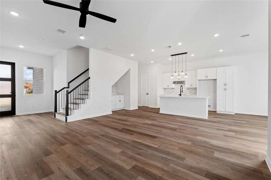Bright kitchen anchored by a sleek island, ideal for both cooking and conversation.