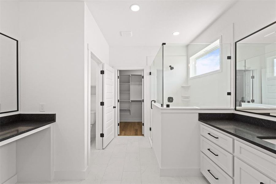 Full bathroom featuring a walk in closet, vanity, walk in shower, and recessed lighting