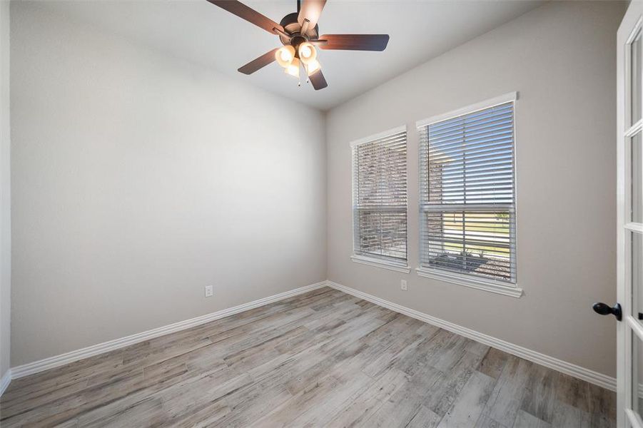 Empty room with light wood-style flooring and ceiling fan Empty room with light wood-style flooring and ceiling fan