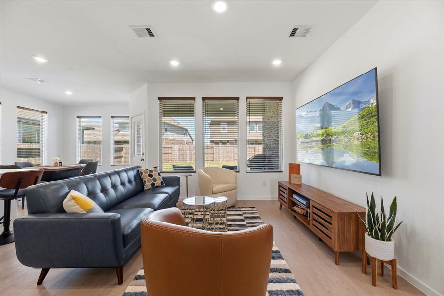 Bright open-concept living area with large windows and natural light.