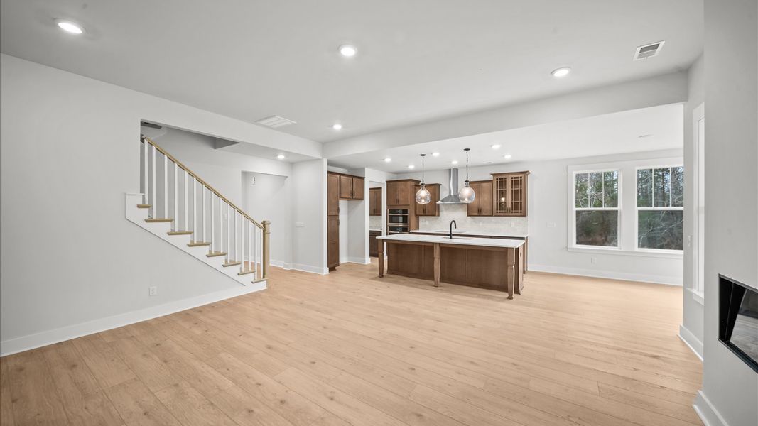 Vibrant and welcoming family room with fireplace anchored by clean lines, tasteful materials, and abundant light