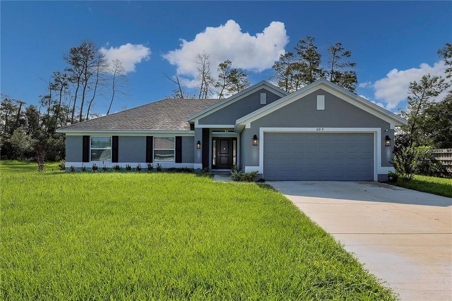Front exterior of a new home in Ocala Waterway / Kingsland Country Estates, Ocala, FL, highlighting curb appeal (Image 2).
