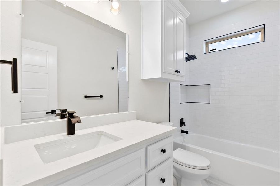 Full bathroom featuring toilet, shower / bath combination, and vanity Full bathroom featuring toilet, shower / bath combination, and vanity