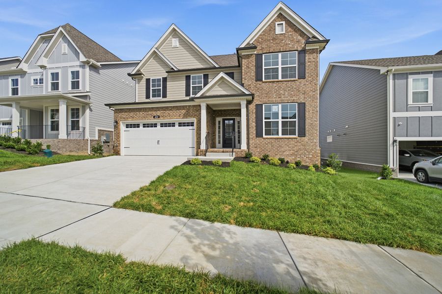 Front exterior of a new home in McCain's Station, Gallatin, TN, highlighting curb appeal (Image 28). Front exterior of a new home in McCain's Station, Gallatin, TN, highlighting curb appeal (Image 28).