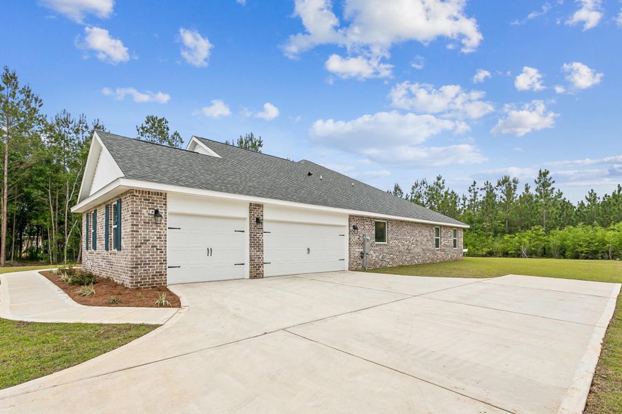 Front exterior of a new home in Walther Reserve, Milton, FL, highlighting curb appeal (Image 22).