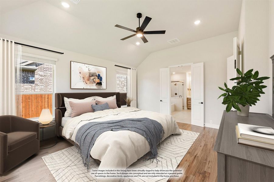Master bedroom with vaulted ceiling, ceiling fan, hardwood floors, and ensuite bathroom doorway visible Master bedroom with vaulted ceiling, ceiling fan, hardwood floors, and ensuite bathroom doorway visible