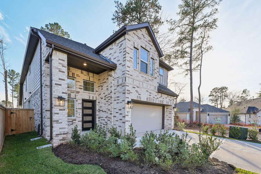 Front exterior of a new home in The Woodlands Hills, Willis, TX, highlighting curb appeal (Image 26).