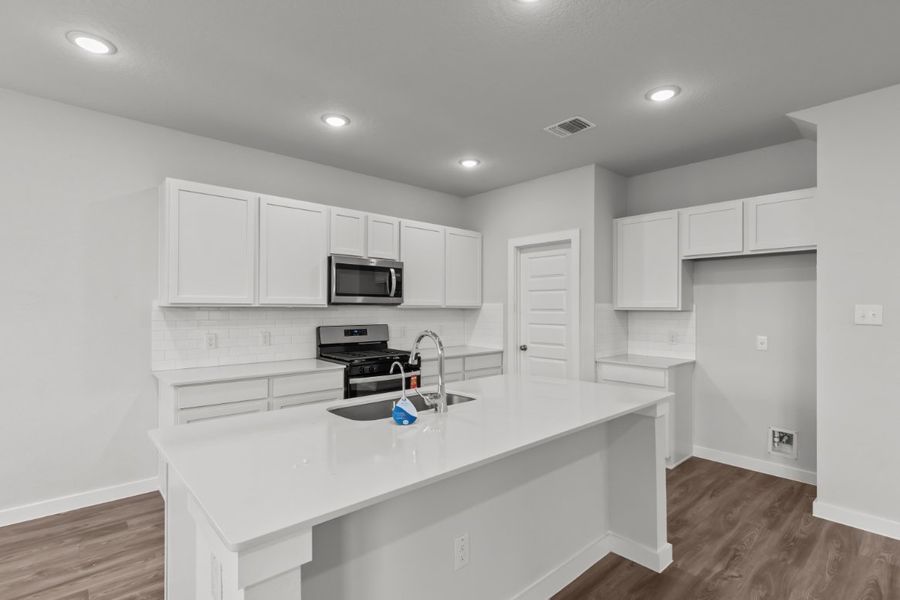 A kitchen with white cabinets. A kitchen with white cabinets.