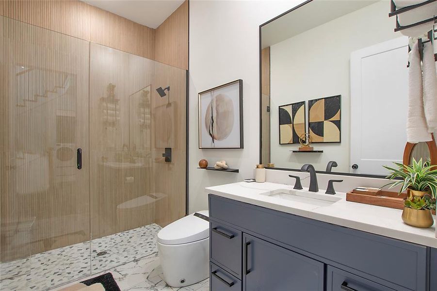 Full bath featuring vanity, a shower stall, and light marble finish floors Full bath featuring vanity, a shower stall, and light marble finish floors