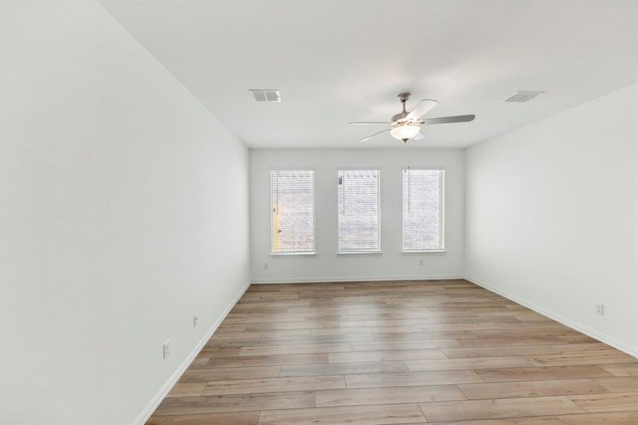 Spare room with ceiling fan and light hardwood / wood-style flooring