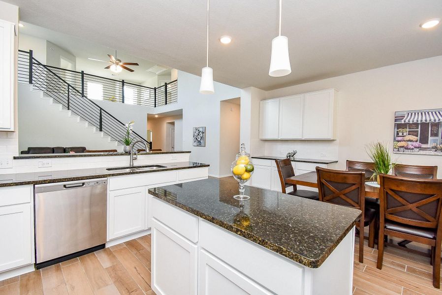 Granite countertops and recessed lighting in the open kitchen. Granite countertops and recessed lighting in the open kitchen.