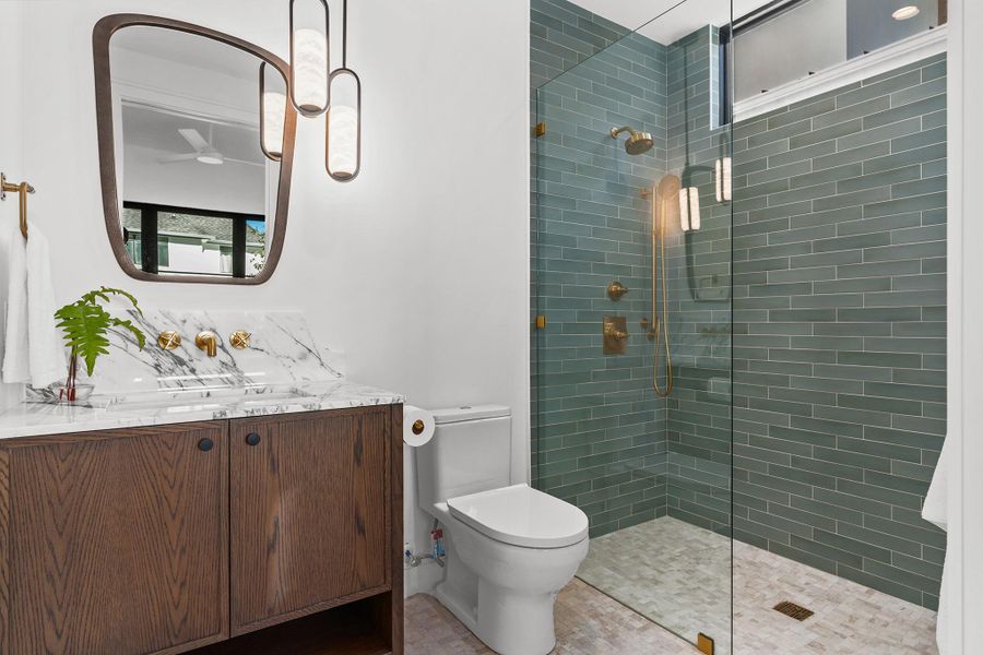 The guest bath sits just off the living room and is complete with a full shower, just steps from the pool through a swing door - no tracking water through the house!