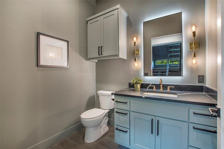 Bathroom with wood-type flooring, toilet, and vanity