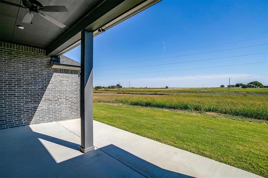 View of patio featuring a rural view and ceiling fan