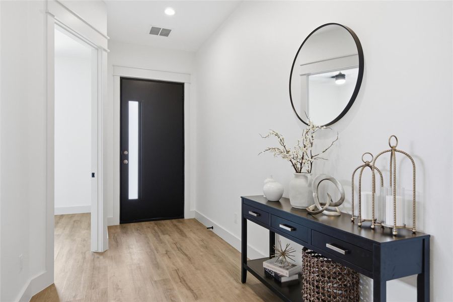A welcoming entry features recessed lighting and durable plank flooring. A welcoming entry features recessed lighting and durable plank flooring.