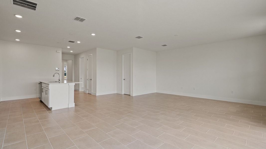 Living Area and Kitchen in the Buttonwood floorplan by DRB Homes at Lakeside at Satilla in Saint Cloud, FL