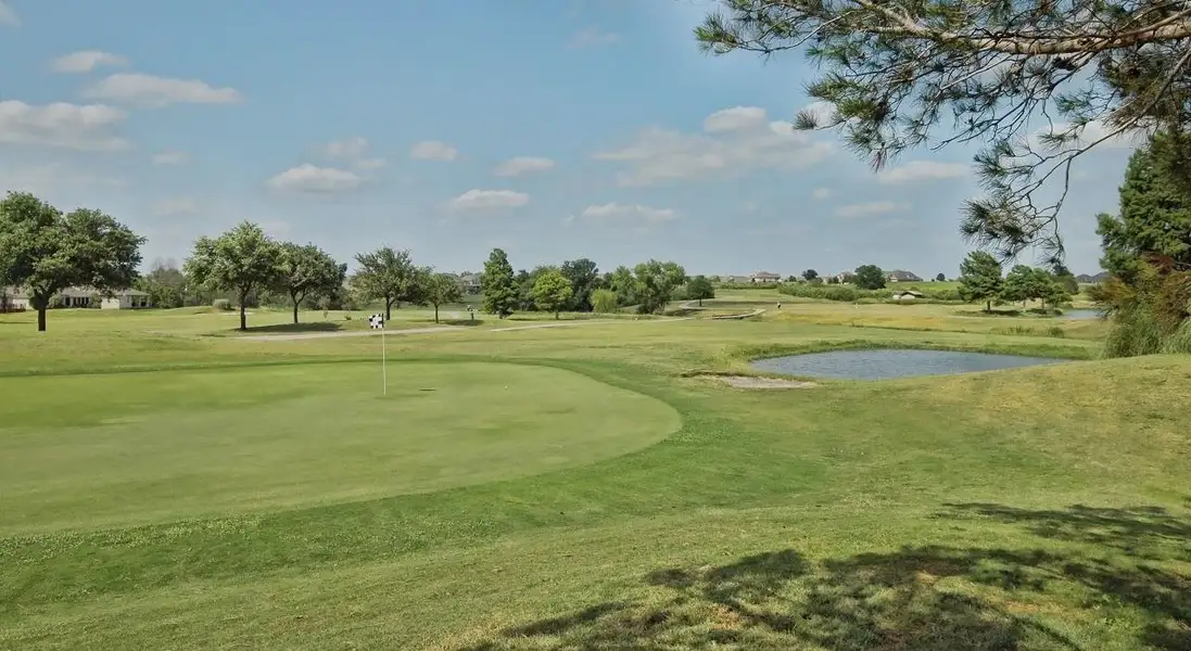 View of property's community featuring a yard, a putting green, view of golf course, and a water view View of property's community featuring a yard, a putting green, view of golf course, and a water view