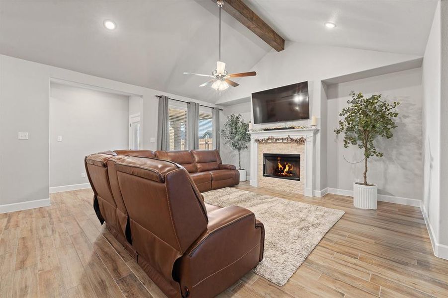 Living area with a fireplace, light wood-style flooring, ceiling fan, and recessed lighting