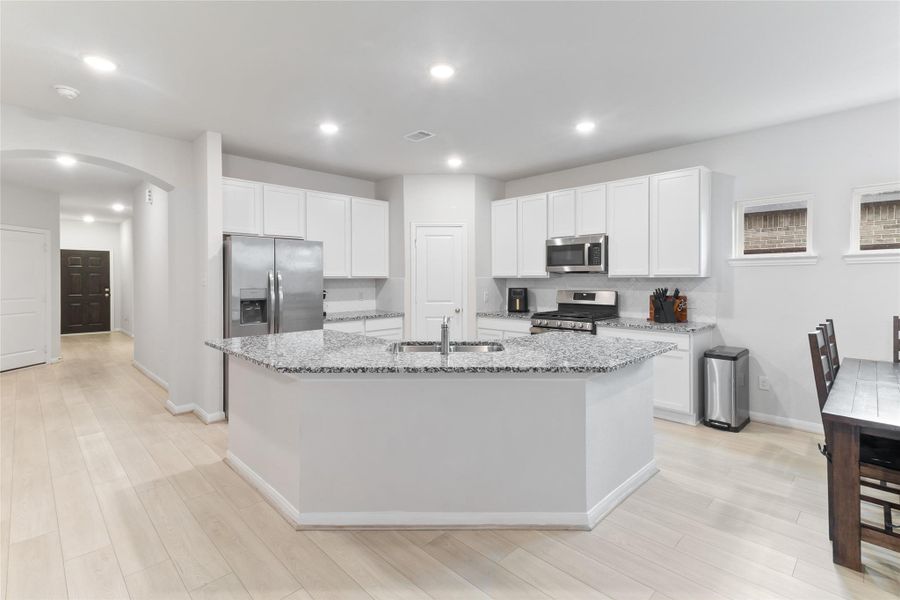 This kitchen features elegant granite countertops, offering both style and durability. This kitchen features elegant granite countertops, offering both style and durability.