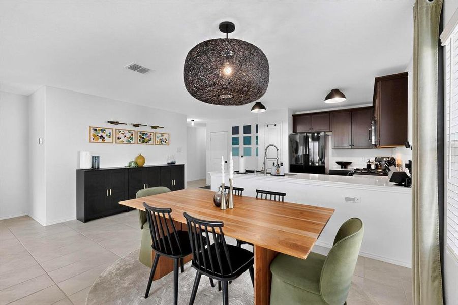 Dining space featuring light tile patterned floors and baseboards Dining space featuring light tile patterned floors and baseboards