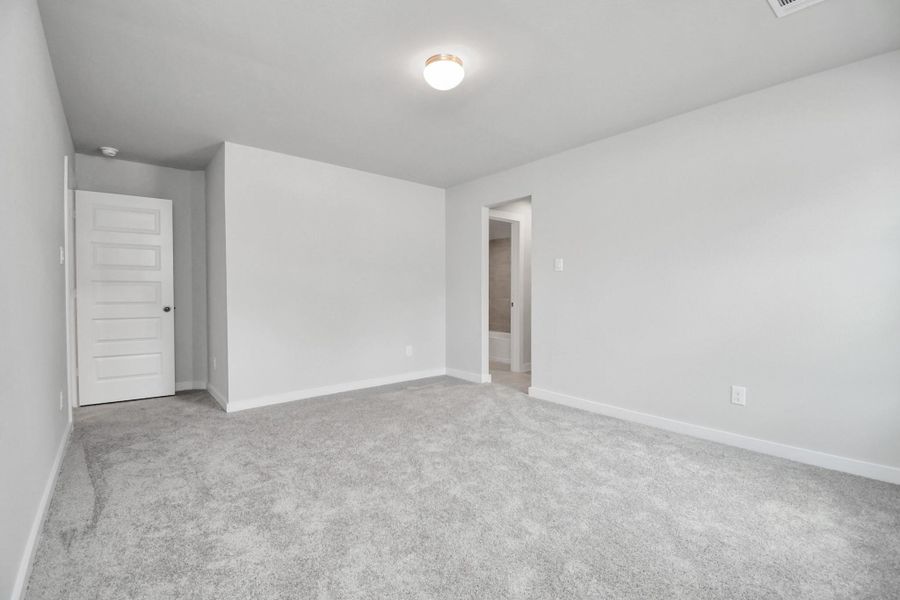 Generously sized secondary bedrooms featuring spacious closets, soft and inviting carpeting underfoot, large windows allowing plenty of natural light, and the added touch of privacy blinds for your personal retreat. Sample photo of completed home with similar floor plan. Actual colors and selections may vary.