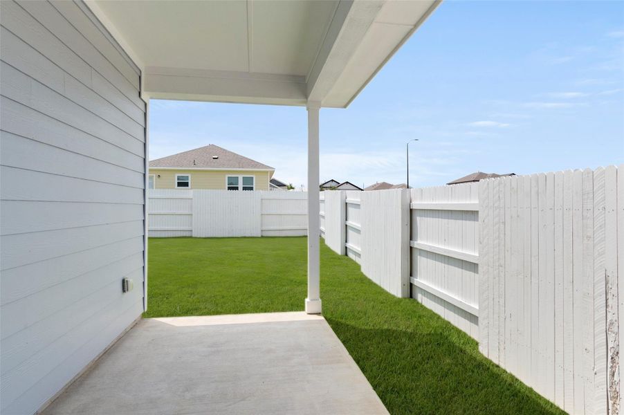 Fenced backyard with a patio area