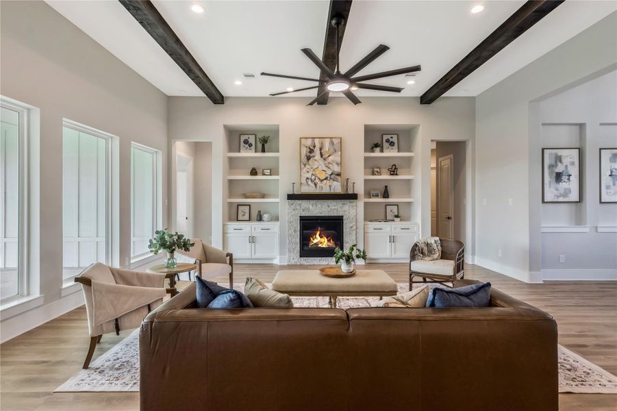 A cozy stone fireplace serves as a focal point, surrounded by built-in shelves A cozy stone fireplace serves as a focal point, surrounded by built-in shelves