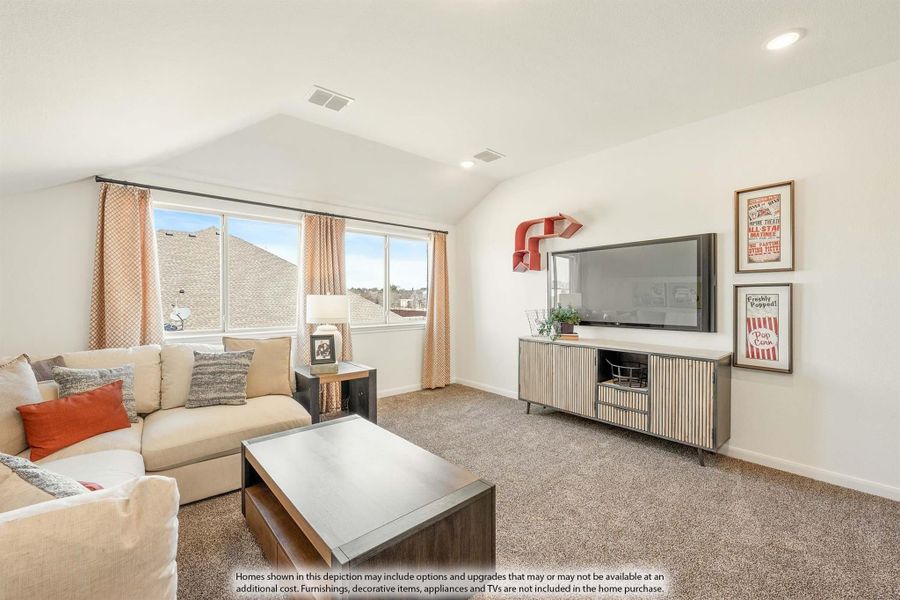 Upstairs living room with vaulted ceiling, carpet flooring, sectional sofa, and wall-mounted TV with media console Upstairs living room with vaulted ceiling, carpet flooring, sectional sofa, and wall-mounted TV with media console