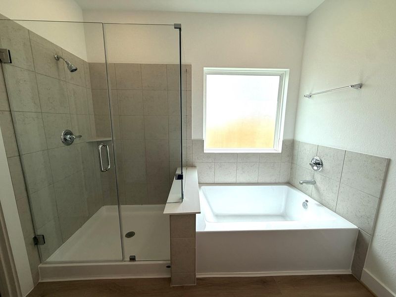 Enjoy the best of both worlds with a separate soaking tub for relaxation and a walk-in glass shower for convenience.
